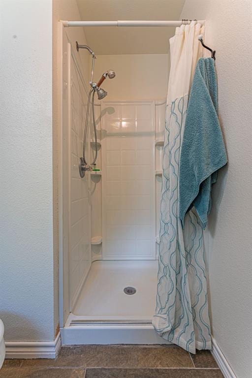 22797 N Henney Rd, Luther, OK 73054 - full bathroom with a stall shower and a textured wall