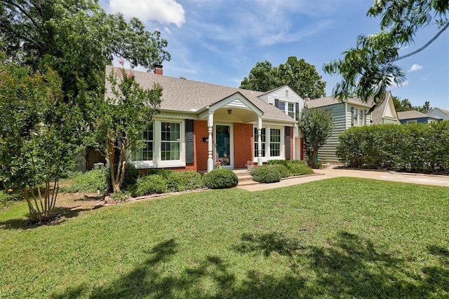 701 NW 46th St, Oklahoma City, OK 73118 - view of front facade featuring a front lawn, brick siding, a chimney, and a shingled roof