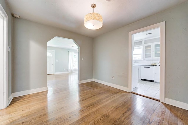 701 NW 46th St, Oklahoma City, OK 73118 - spare room with arched walkways and light wood-style floors