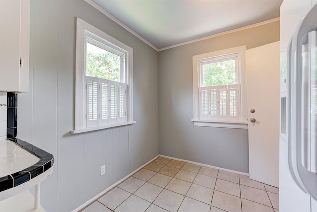 701 NW 46th St, Oklahoma City, OK 73118 - unfurnished dining area with light tile patterned flooring and crown molding