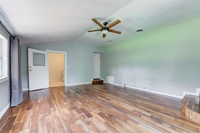 701 NW 46th St, Oklahoma City, OK 73118 - unfurnished living room with a ceiling fan, wood finished floors, and lofted ceiling