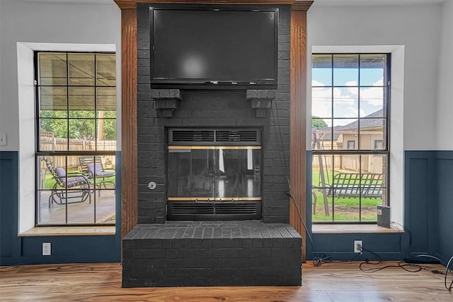 3208 Quail Cir, Altus, OK 73521 - detailed view of a brick fireplace and wood finished floors