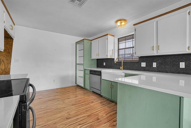 3208 Quail Cir, Altus, OK 73521 - kitchen with stainless steel dishwasher, black range with electric cooktop, green cabinets, light wood-style floors, and tasteful backsplash