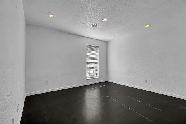 3208 Quail Cir, Altus, OK 73521 - spare room featuring concrete floors, recessed lighting, and a textured ceiling