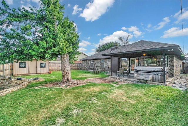 3208 Quail Cir, Altus, OK 73521 - fenced backyard featuring a hot tub, a patio area, a trampoline, and a shed
