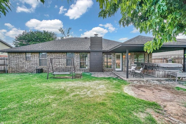 3208 Quail Cir, Altus, OK 73521 - rear view of house with a hot tub, a patio area, brick siding, a chimney, and a shingled roof