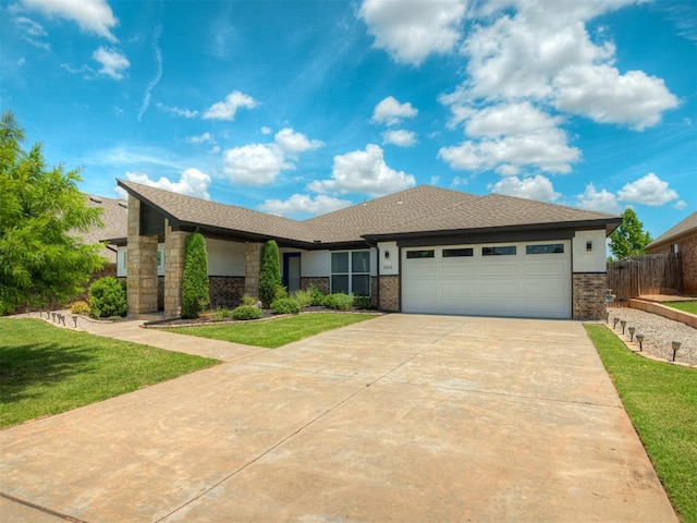 3903 Painted Bird Ln, Norman, OK 73071 - view of front facade featuring brick siding, a garage, and concrete driveway