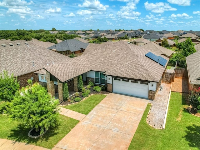 3903 Painted Bird Ln, Norman, OK 73071 - view of front of house with a garage, a residential view, concrete driveway, and stone siding