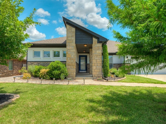 3903 Painted Bird Ln, Norman, OK 73071 - view of front of house with stone siding, a front yard, and roof with shingles