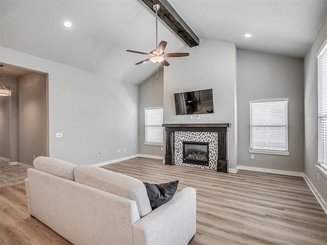 3903 Painted Bird Ln, Norman, OK 73071 - living area featuring light wood finished floors, beam ceiling, a tile fireplace, ceiling fan, and recessed lighting