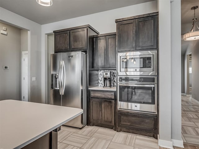 3903 Painted Bird Ln, Norman, OK 73071 - kitchen featuring stainless steel appliances, dark brown cabinets, and light countertops
