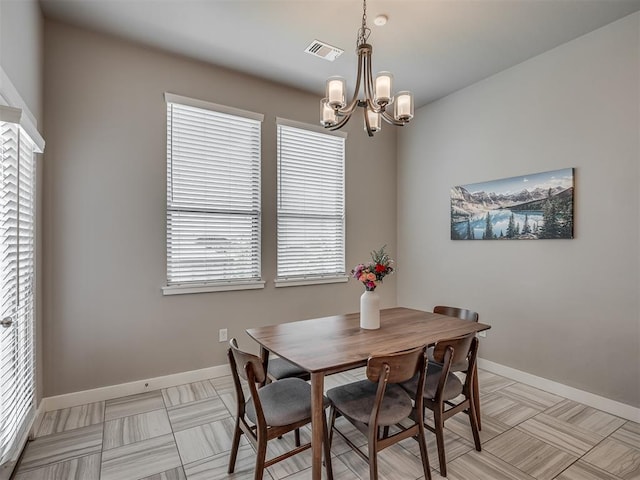 3903 Painted Bird Ln, Norman, OK 73071 - dining area featuring a chandelier and baseboards