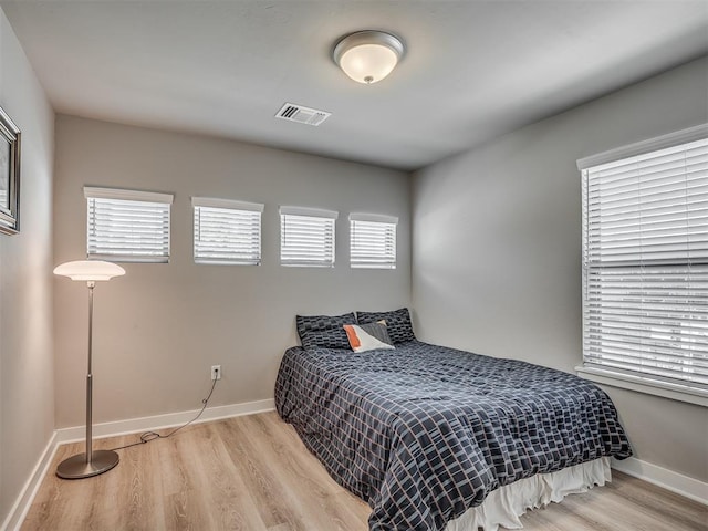 3903 Painted Bird Ln, Norman, OK 73071 - bedroom featuring wood finished floors and multiple windows
