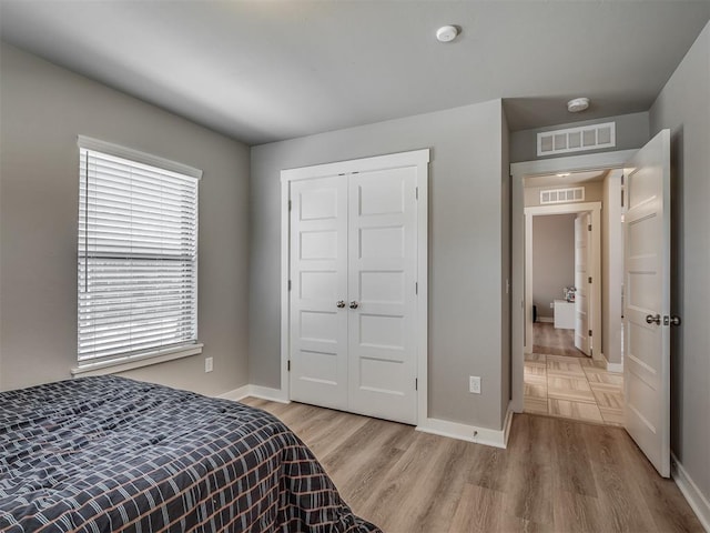 3903 Painted Bird Ln, Norman, OK 73071 - bedroom with light wood-style floors and a closet