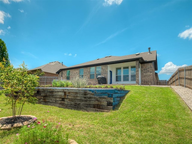 3903 Painted Bird Ln, Norman, OK 73071 - back of house featuring a fenced backyard and brick siding