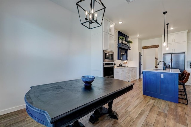 13513 NW 1st St, Yukon, OK 73099 - dining area featuring light wood-style floors, a chandelier, and recessed lighting