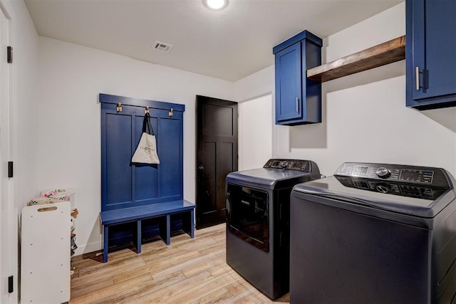 13513 NW 1st St, Yukon, OK 73099 - laundry room with cabinet space, washer and dryer, and light wood-style flooring