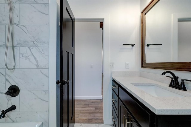 13513 NW 1st St, Yukon, OK 73099 - full bath featuring vanity, wood finished floors, and shower / washtub combination