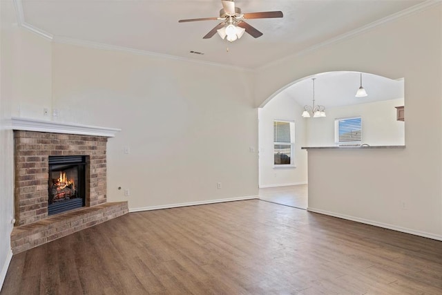 11829 NW 133rd St, Piedmont, OK 73078 - unfurnished living room with wood finished floors, a chandelier, crown molding, ceiling fan, and a brick fireplace