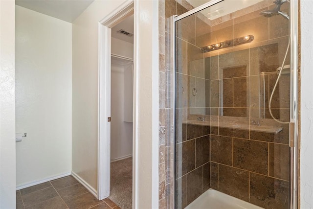 11829 NW 133rd St, Piedmont, OK 73078 - bathroom featuring a stall shower, a spacious closet, and tile patterned floors