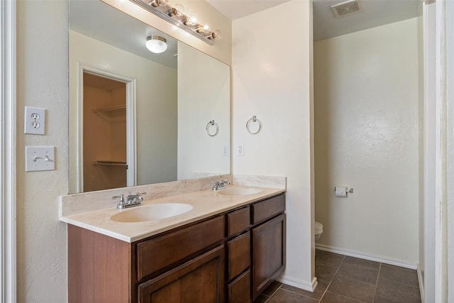 11829 NW 133rd St, Piedmont, OK 73078 - bathroom with double vanity, tile patterned floors, and a spacious closet