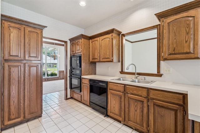 8317 NW 105th St, Oklahoma City, OK 73162 - kitchen with black appliances, wallpapered walls, light countertops, brown cabinetry, and light tile patterned floors