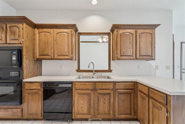 8317 NW 105th St, Oklahoma City, OK 73162 - kitchen featuring black appliances, wallpapered walls, a peninsula, light countertops, and brown cabinetry