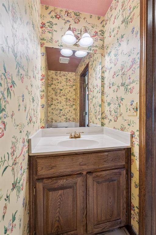 8317 NW 105th St, Oklahoma City, OK 73162 - bathroom featuring wallpapered walls and vanity