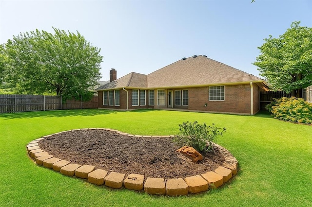 8317 NW 105th St, Oklahoma City, OK 73162 - rear view of house featuring a fenced backyard, a chimney, and brick siding
