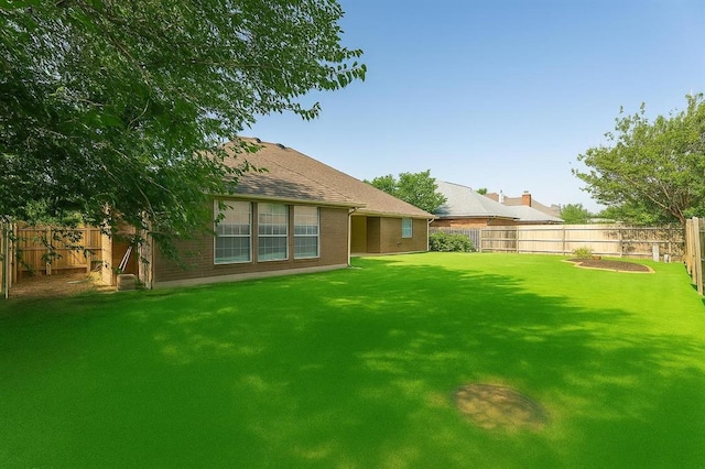 8317 NW 105th St, Oklahoma City, OK 73162 - rear view of property featuring a fenced backyard and brick siding