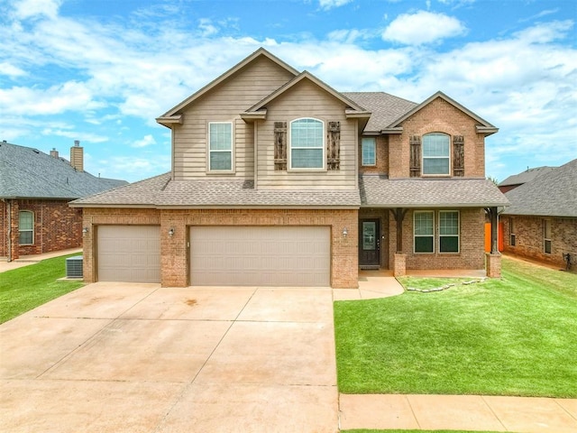 2313 NW 154th St, Edmond, OK 73013 - view of front facade featuring a shingled roof, brick siding, a front yard, and a garage