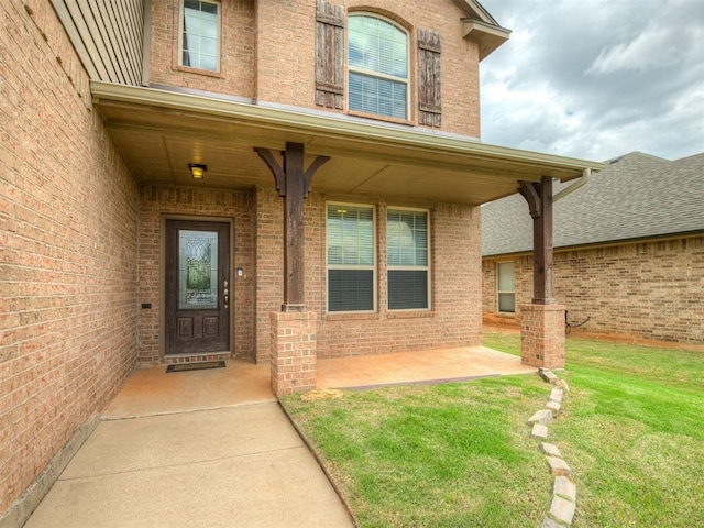 2313 NW 154th St, Edmond, OK 73013 - doorway to property with brick siding and a yard