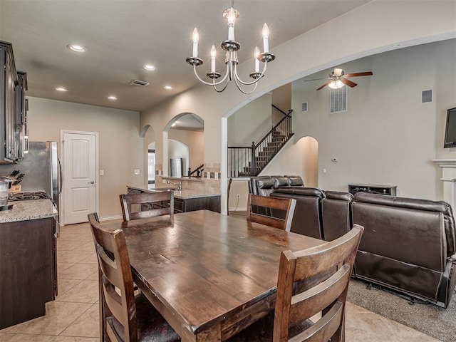 2313 NW 154th St, Edmond, OK 73013 - dining area with arched walkways, a ceiling fan, stairway, light tile patterned floors, and recessed lighting
