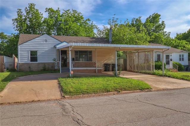 4012 SE 25th St, Del City, OK 73115 - view of front of property featuring a porch, an attached carport, driveway, and a front lawn