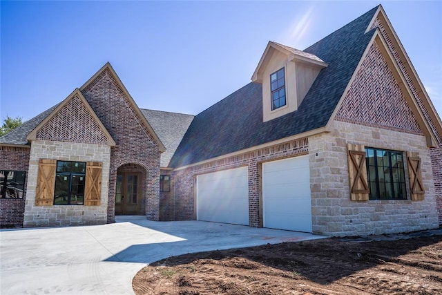 3124 Red Ridge Dr, Blanchard, OK 73010 - french country inspired facade with stone siding, concrete driveway, a garage, and roof with shingles
