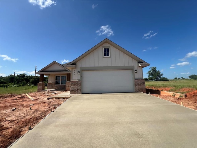 681 Cedar Hill Way, Washington, OK 73093 - view of front of house featuring brick siding, an attached garage, driveway, and board and batten siding