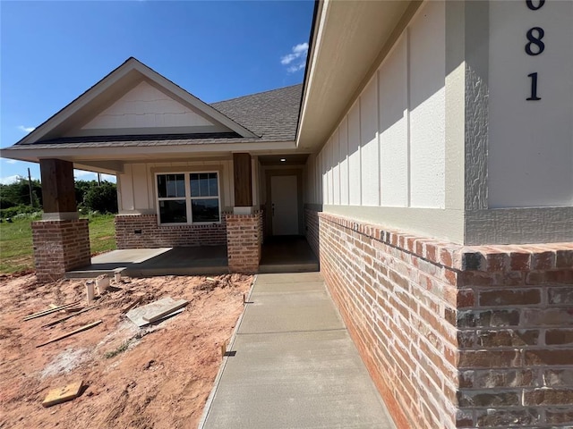 681 Cedar Hill Way, Washington, OK 73093 - view of exterior entry with brick siding, board and batten siding, and roof with shingles