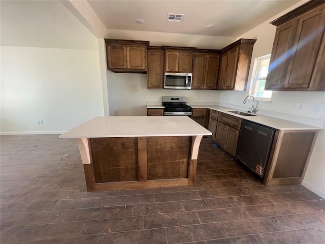 681 Cedar Hill Way, Washington, OK 73093 - kitchen with appliances with stainless steel finishes, a kitchen island, light countertops, and dark brown cabinetry