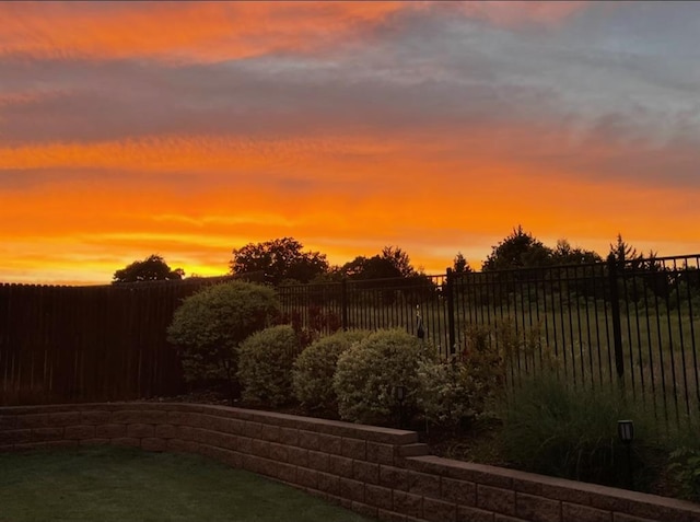 6301 Oxnard St, Edmond, OK 73034 - yard at dusk featuring a fenced backyard