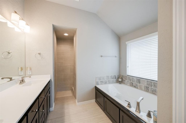 6301 Oxnard St, Edmond, OK 73034 - full bathroom featuring vanity, a garden tub, and lofted ceiling