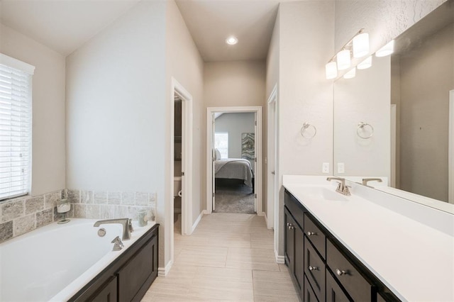 6301 Oxnard St, Edmond, OK 73034 - bathroom with vanity, a garden tub, and connected bathroom