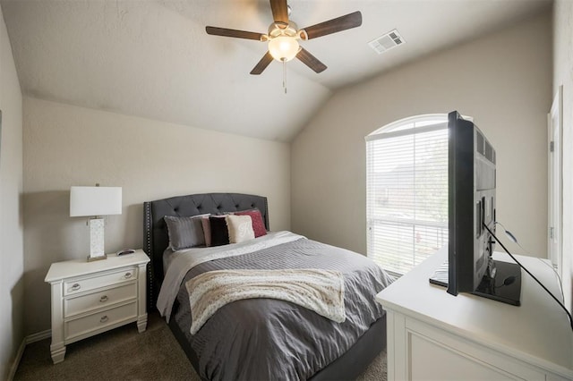 6301 Oxnard St, Edmond, OK 73034 - bedroom featuring dark colored carpet, vaulted ceiling, and a ceiling fan
