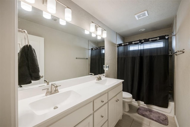 6301 Oxnard St, Edmond, OK 73034 - bathroom with double vanity, shower / bathtub combination with curtain, a textured ceiling, and a textured wall