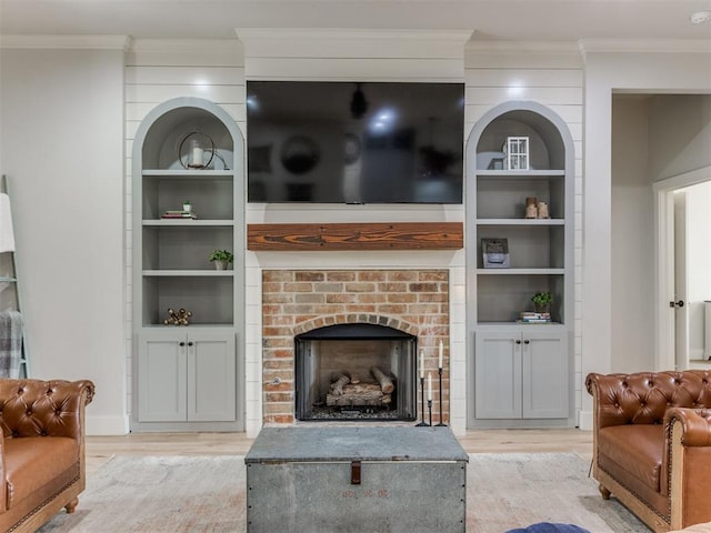 2209 Marjorie Ln, Yukon, OK 73099 - living area featuring light wood-style floors, ornamental molding, a brick fireplace, and built in features