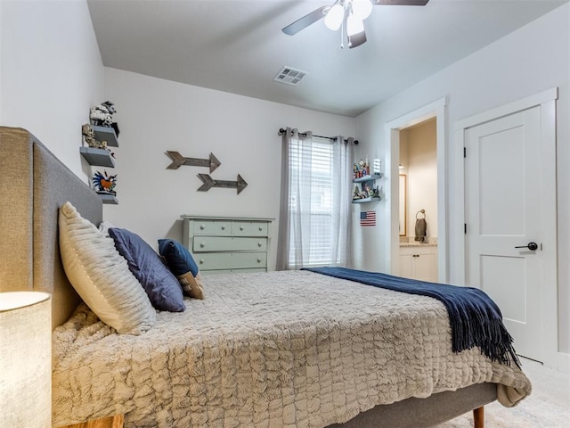 2209 Marjorie Ln, Yukon, OK 73099 - carpeted bedroom featuring ceiling fan and ensuite bath