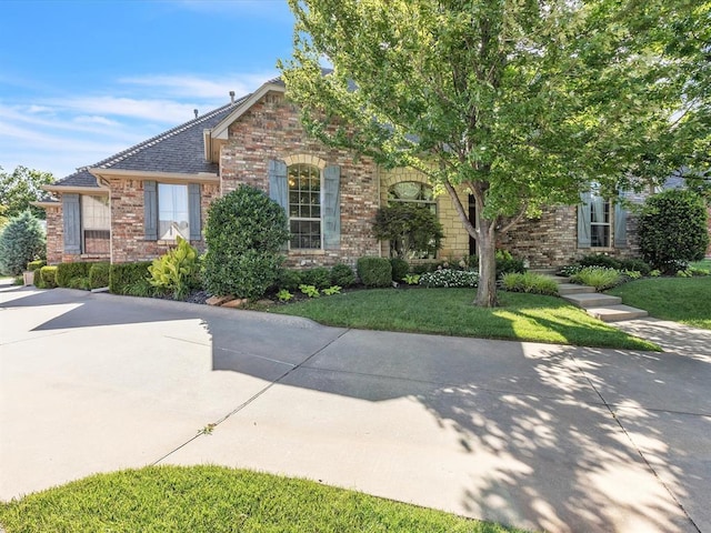 4109 Riva Ridge Ct, Edmond, OK 73003 - obstructed view of property featuring brick siding and a front yard