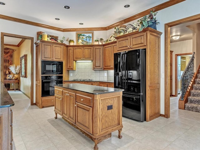 4109 Riva Ridge Ct, Edmond, OK 73003 - kitchen featuring black appliances, brown cabinets, tasteful backsplash, dark stone countertops, and a kitchen island