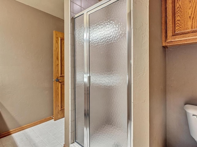 4109 Riva Ridge Ct, Edmond, OK 73003 - bathroom featuring a textured wall, a stall shower, and tile patterned floors