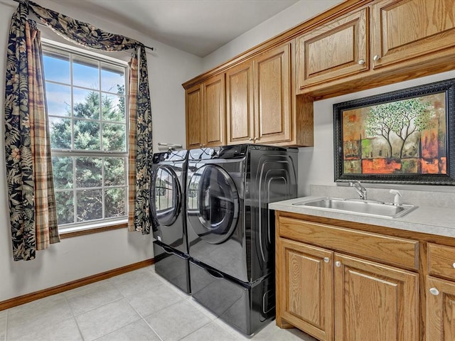 4109 Riva Ridge Ct, Edmond, OK 73003 - washroom featuring washer and clothes dryer, cabinet space, and light tile patterned flooring