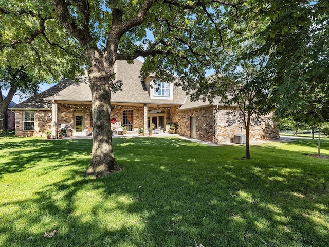 4109 Riva Ridge Ct, Edmond, OK 73003 - view of front of property featuring a front lawn, a shingled roof, a patio area, and brick siding